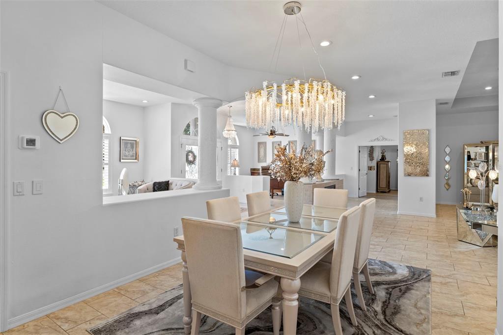 4061 Misty View Drive Spring Hill, FL 34609 - Photo 13 of 70 a view of a dining room with furniture and wooden floor