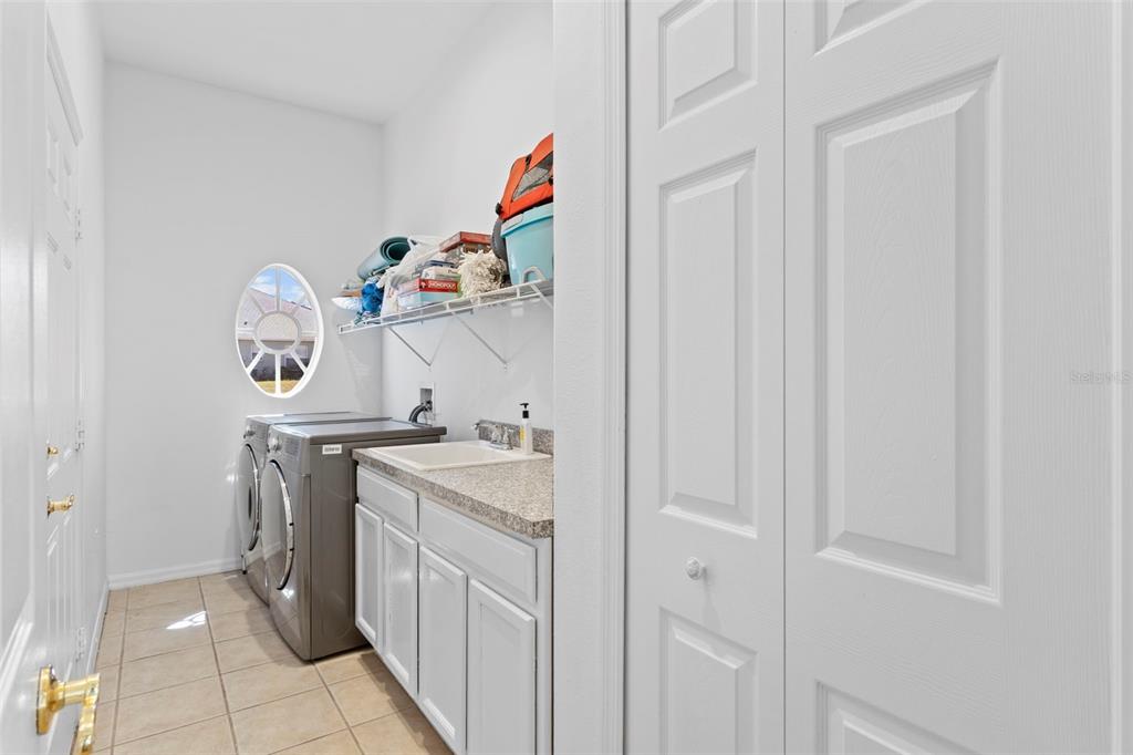 4061 Misty View Drive Spring Hill, FL 34609 - Photo 40 of 70 a utility room with dryer washer and a view of living room