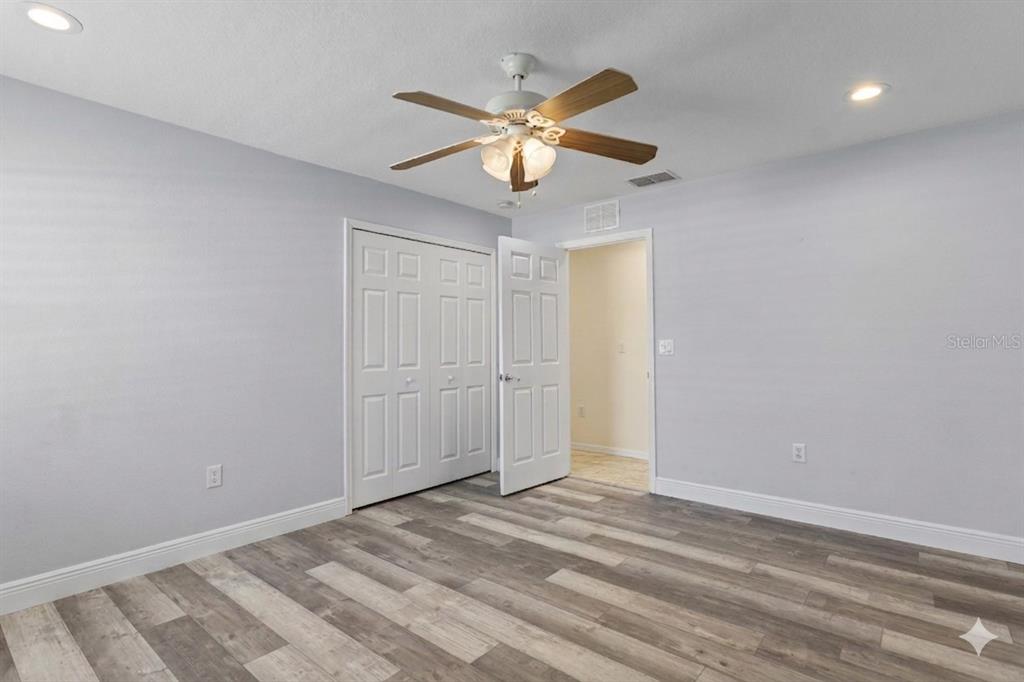 4061 Misty View Drive Spring Hill, FL 34609 - Photo 44 of 70 a view of a livingroom with a ceiling fan and wooden floor