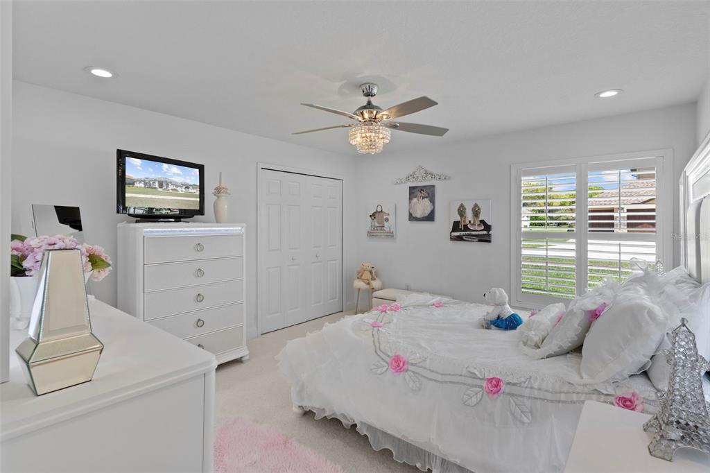 4061 Misty View Drive Spring Hill, FL 34609 - Photo 45 of 70 a bedroom with a bed and a chandelier