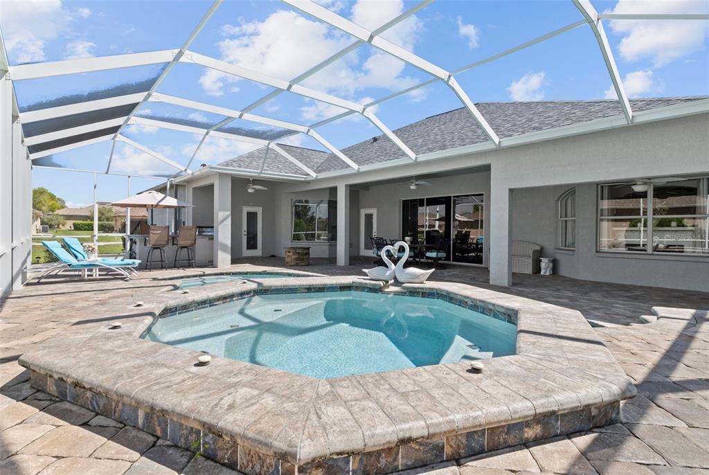 4061 Misty View Drive Spring Hill, FL 34609 - Photo 57 of 70 a view of a swimming pool with a outdoor seating