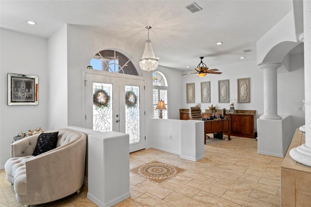 4061 Misty View Drive Spring Hill, FL 34609 - Photo 7 of 70 a living room with furniture and a chandelier