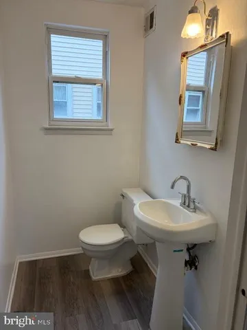 a bathroom with a sink toilet and a mirror