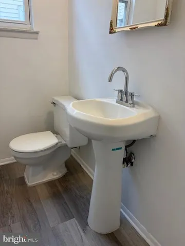 a bathroom with a sink toilet and a mirror