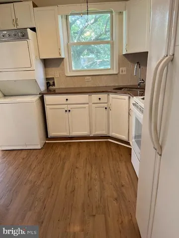 a kitchen with a sink a refrigerator and window
