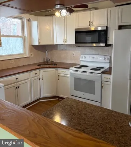 a kitchen with a sink and a microwave