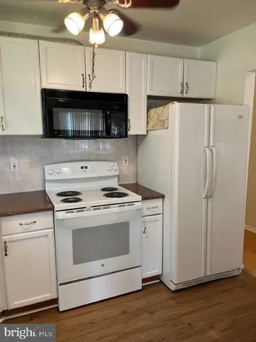 a kitchen with a stove a sink and a refrigerator