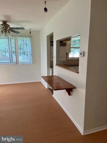 an empty room with windows and fireplace