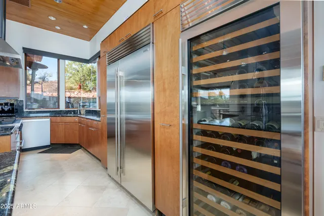 a living room with furniture a flat screen tv and a floor to ceiling window