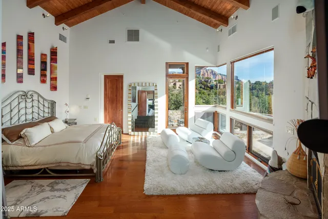 a living room with furniture and a floor to ceiling window