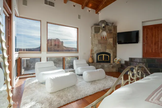 a living room with furniture and a floor to ceiling window