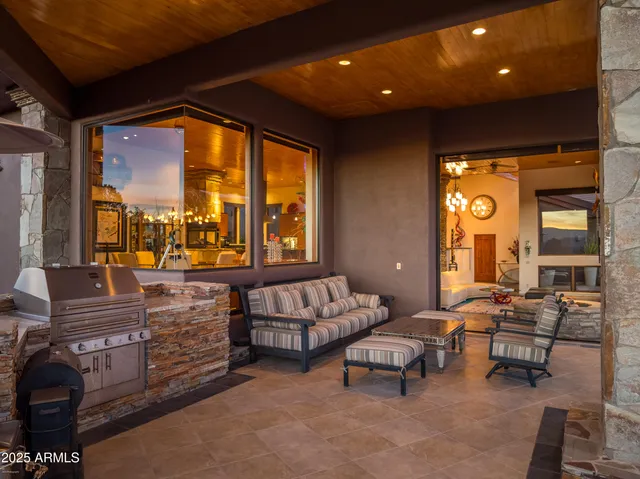 a living room with furniture and floor to ceiling window