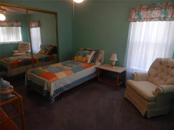 a bedroom with a bed couch and window