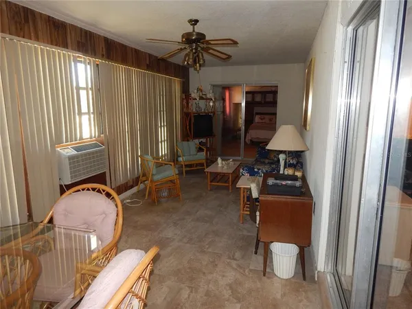 a living room with furniture and a floor to ceiling window