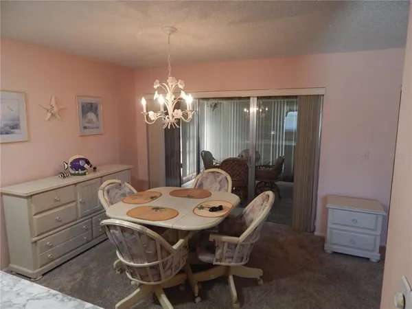 a dining room with furniture and chandelier