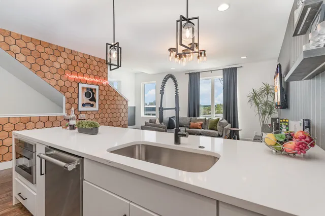a kitchen with a sink and a chandelier