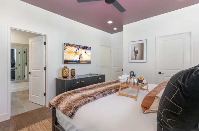 a bedroom with a bed and a flat screen tv