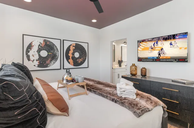 a bedroom with a bed and a flat screen tv