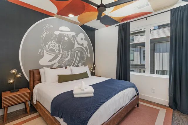 a bedroom with a bed and lamp with the dresser