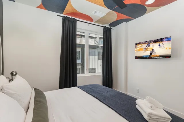 a bedroom with a bed and a painting on the wall