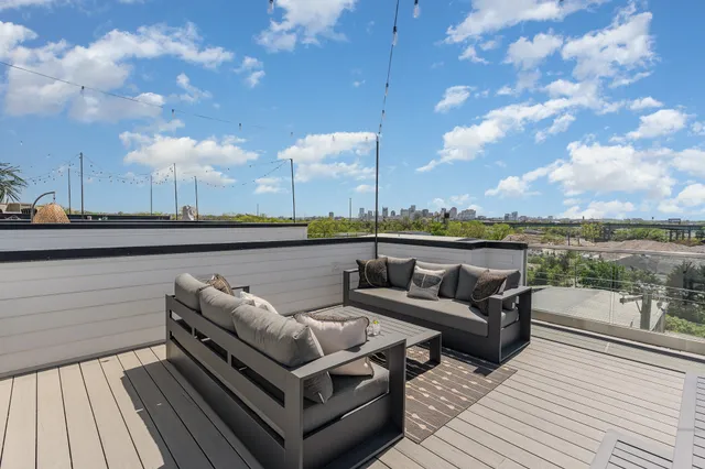 a view of a terrace with couches and lounge chairs
