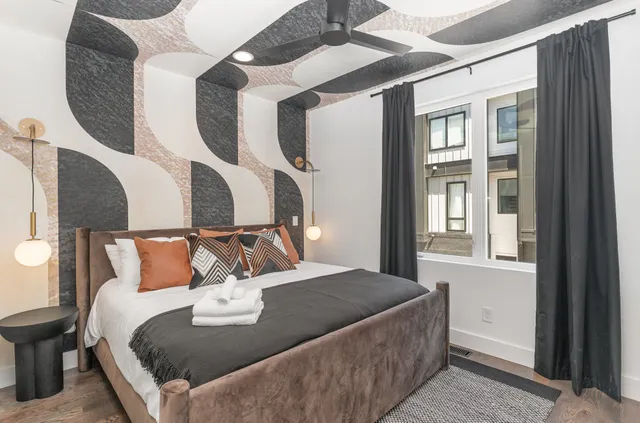 a bed sitting in a bedroom next to a window