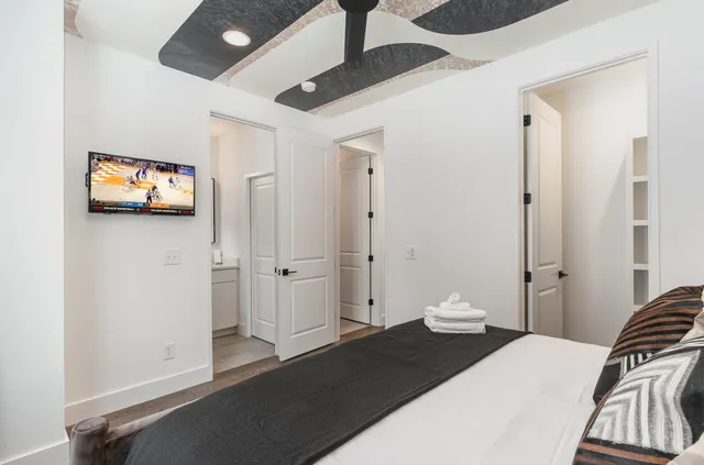 a bedroom with a bed and a tv