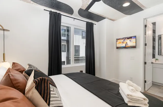 a bedroom with a bed and glass window