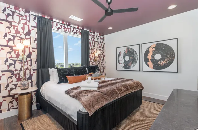 a bedroom with a large bed and a chandelier