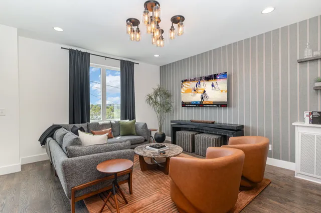 a living room with furniture a large window and a flat screen tv