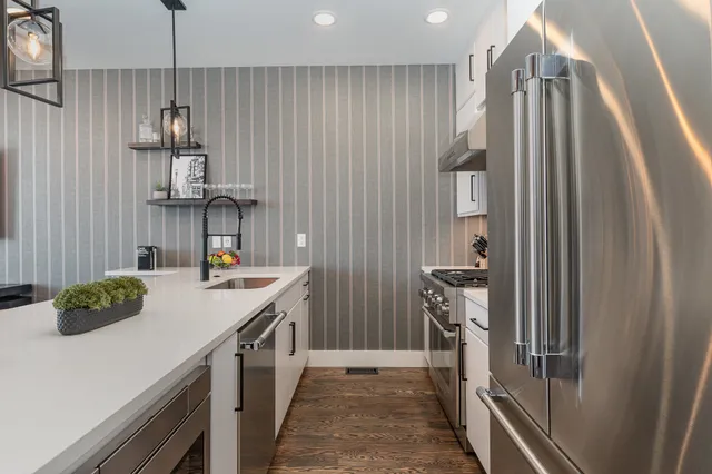 a kitchen with a sink and refrigerator