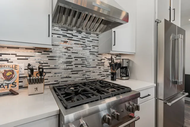 a kitchen with a stove and a refrigerator
