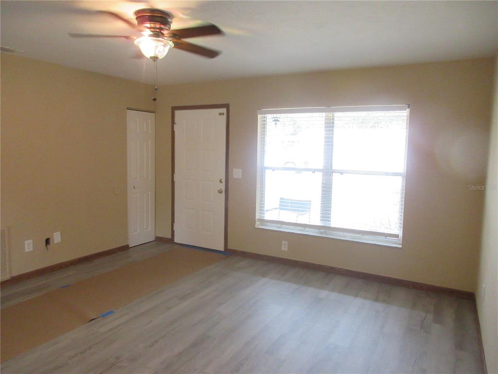2601 Southeast 175th Terrace Road Silver Springs, FL 34488 - Photo 20 of 87 an empty room with a window and a fan