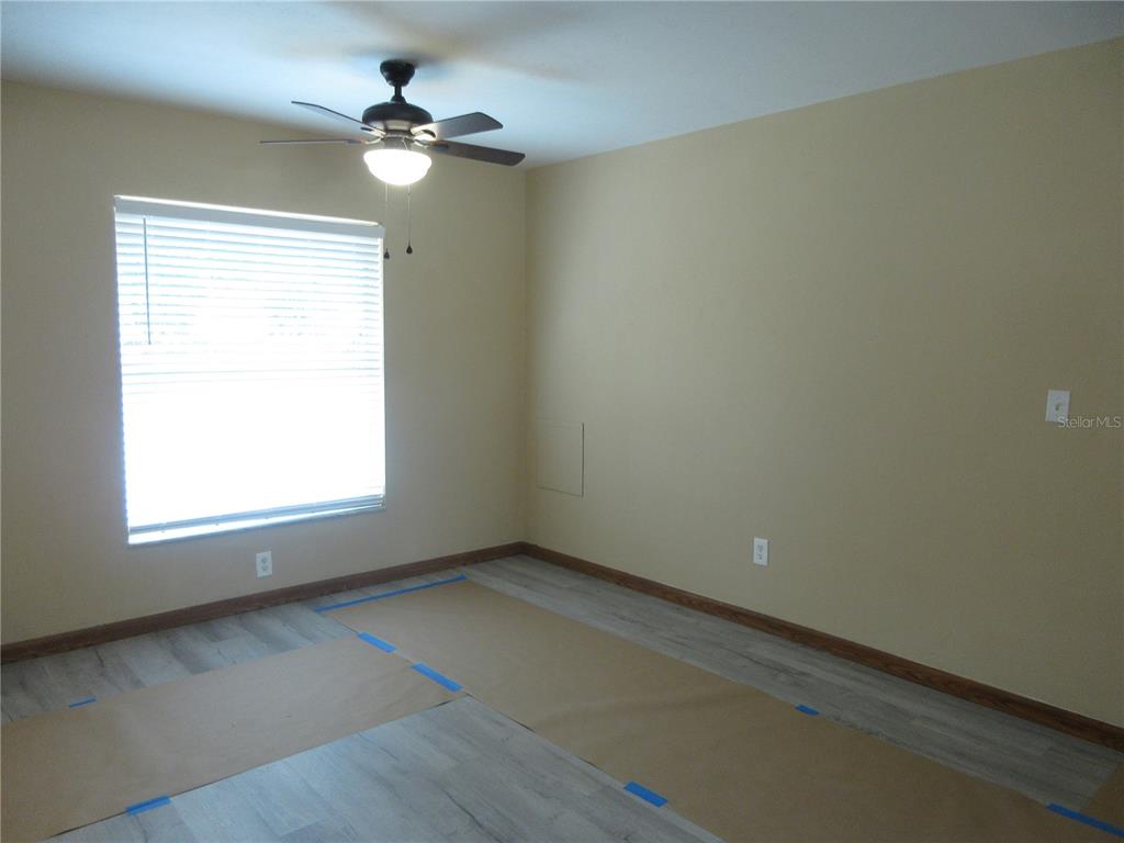 2601 Southeast 175th Terrace Road Silver Springs, FL 34488 - Photo 23 of 87 an empty room with a window and a ceiling fan