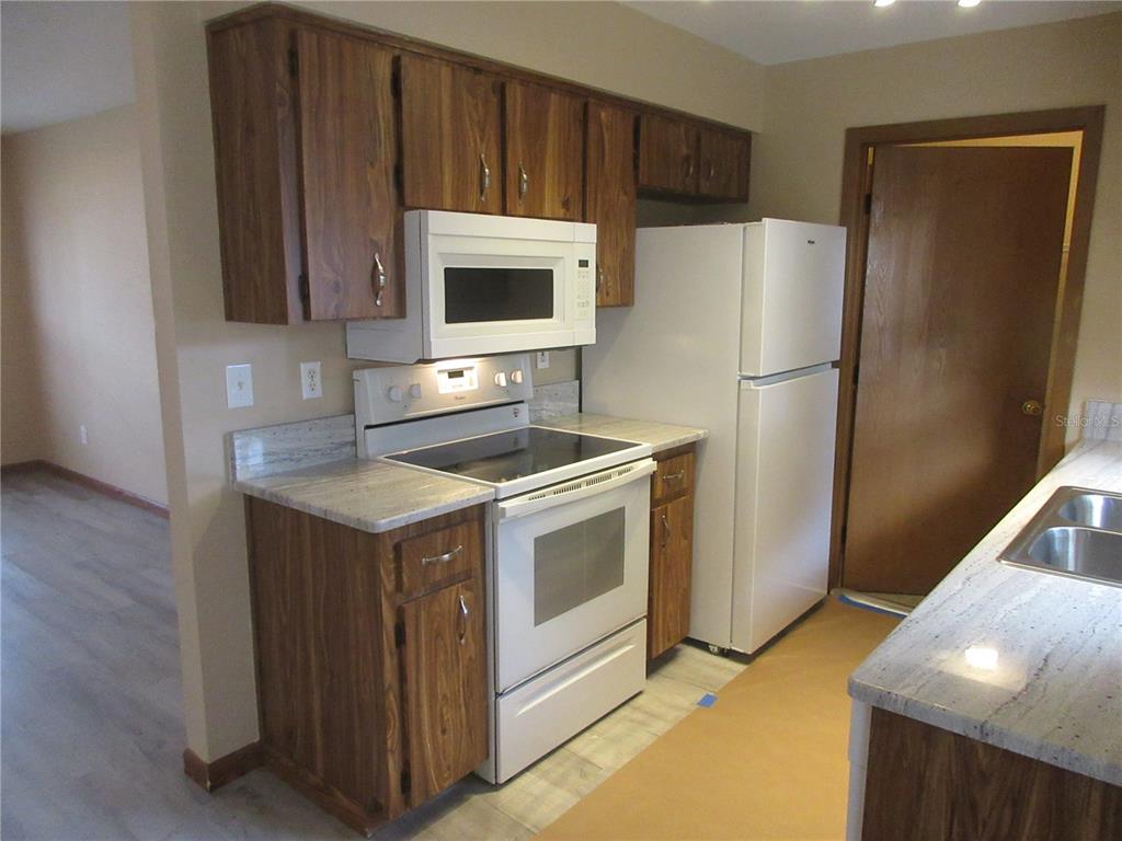 2601 Southeast 175th Terrace Road Silver Springs, FL 34488 - Photo 32 of 87 a kitchen with stainless steel appliances a refrigerator stove and microwave