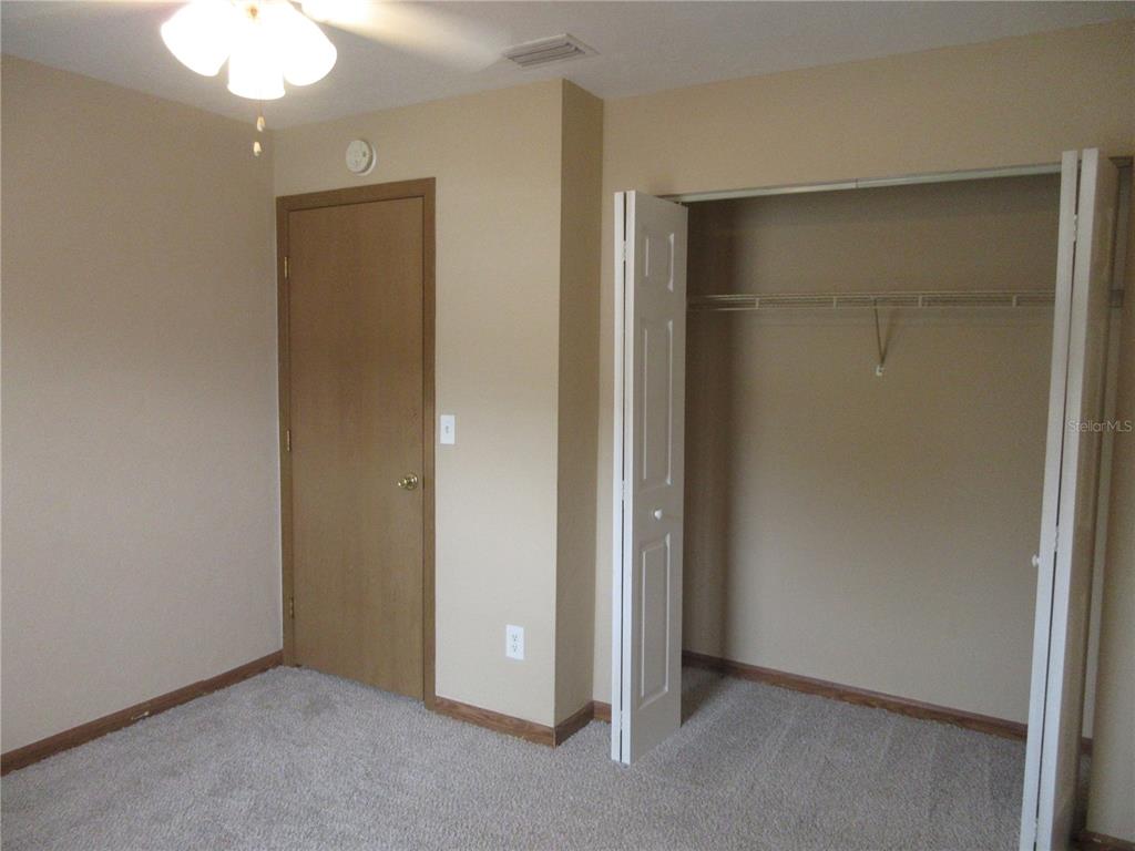2601 Southeast 175th Terrace Road Silver Springs, FL 34488 - Photo 42 of 87 an empty room with closet and a chandelier fan