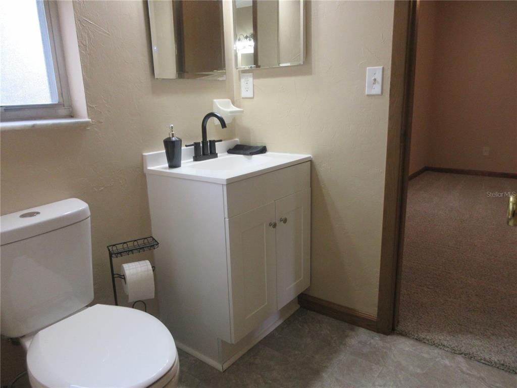 2601 Southeast 175th Terrace Road Silver Springs, FL 34488 - Photo 44 of 87 a bathroom with a toilet sink and mirror