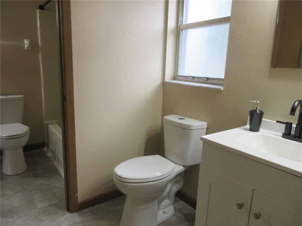 2601 Southeast 175th Terrace Road Silver Springs, FL 34488 - Photo 45 of 87 a white toilet sitting next to a bathroom sink