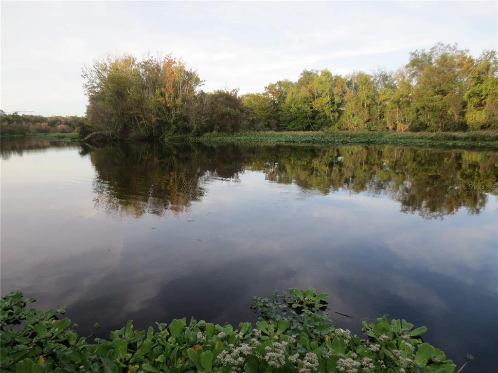 2601 Southeast 175th Terrace Road Silver Springs, FL 34488 - Photo 73 of 87 a view of a lake with a mountain in the background