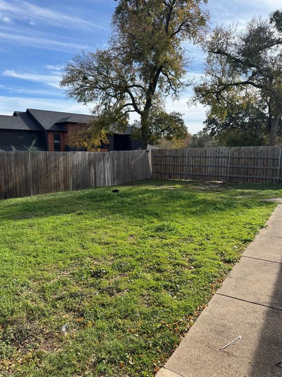 9551 Lechner Road, Unit G Fort Worth, TX 76179 - Photo 4 of 15 Expansive grassy yard with perimeter wood fencing