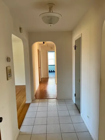 a view of a hallway with wooden shelves