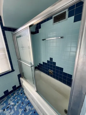 a bathroom with a bathtub and shower