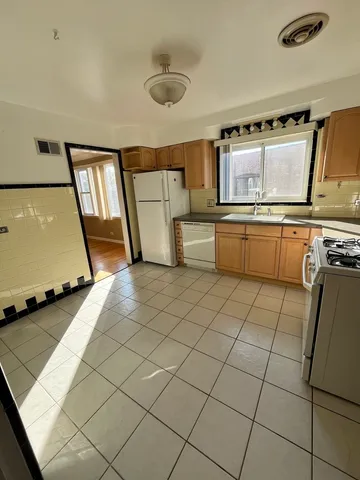 a kitchen with a sink a stove and cabinets