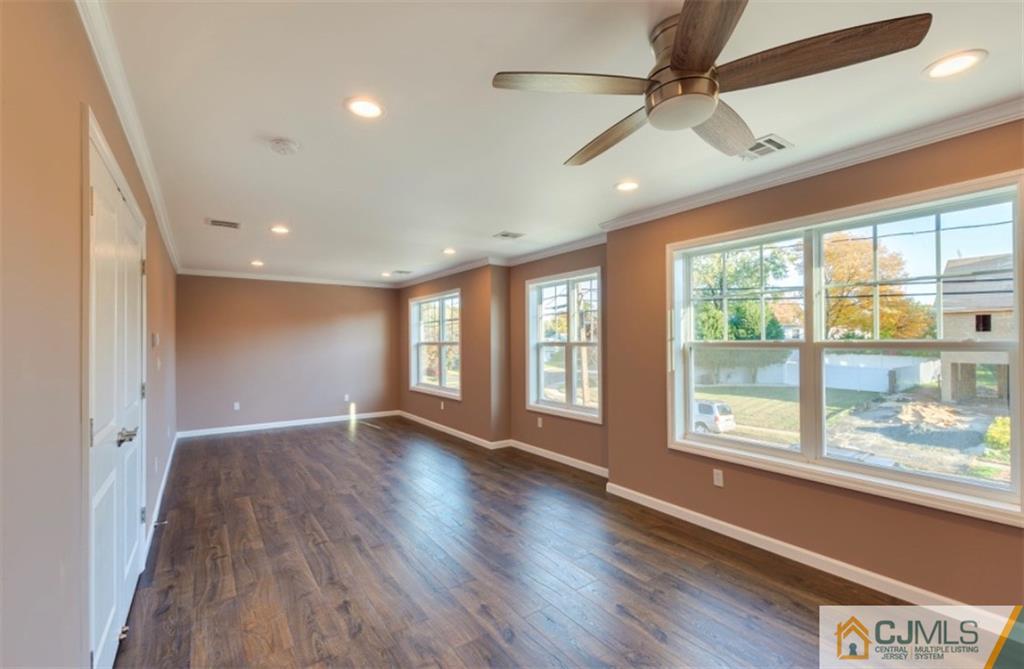 10 Markham Road Edison, NJ 08817 - Photo 12 of 23 a view of an empty room with a window and wooden floor