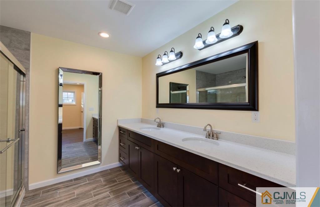 10 Markham Road Edison, NJ 08817 - Photo 15 of 23 a bathroom with a double vanity sink and mirror