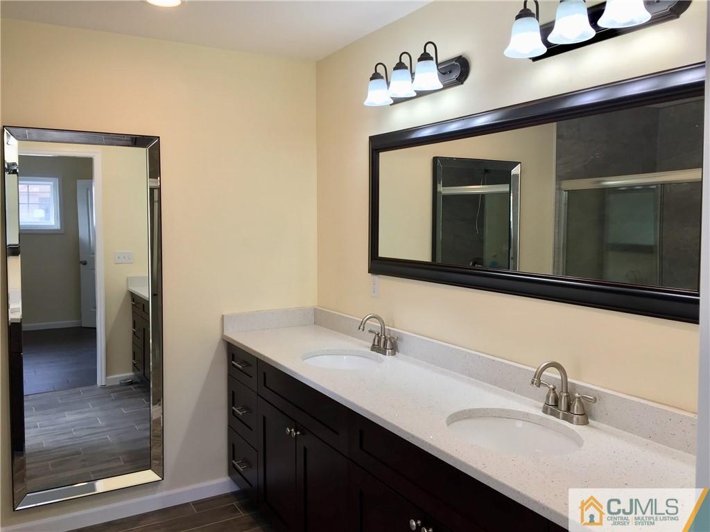 10 Markham Road Edison, NJ 08817 - Photo 16 of 23 a bathroom with a sink and a mirror
