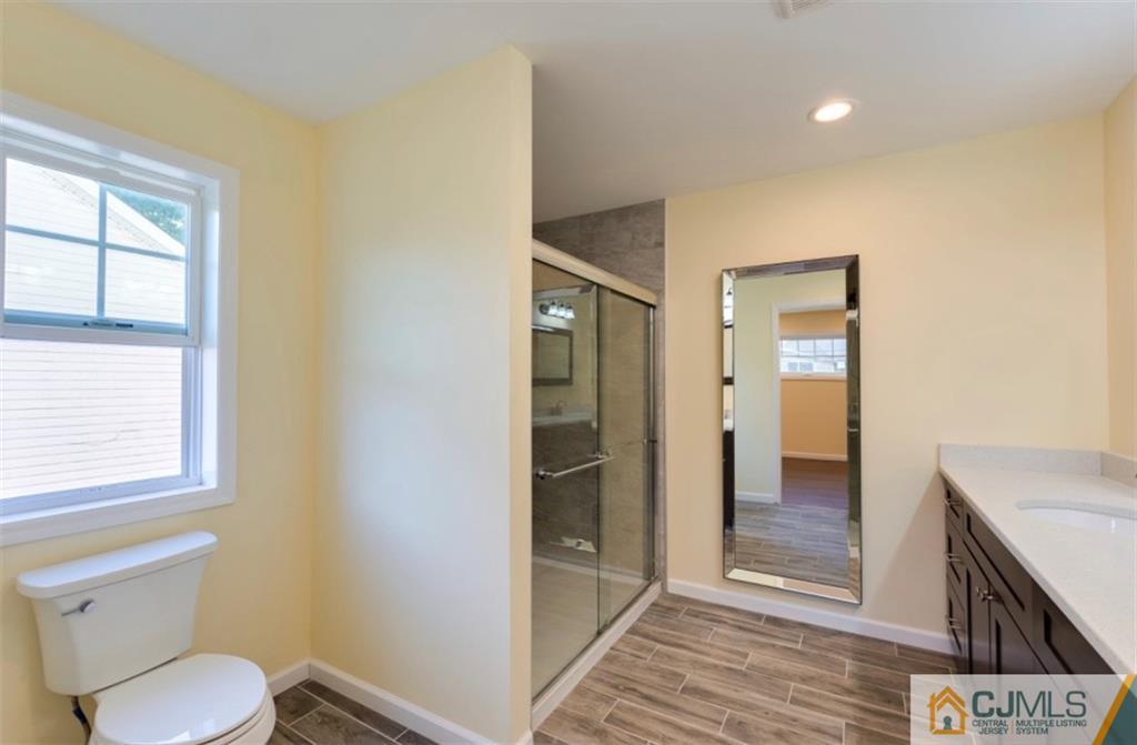 10 Markham Road Edison, NJ 08817 - Photo 17 of 23 a bathroom with a toilet sink and a shower
