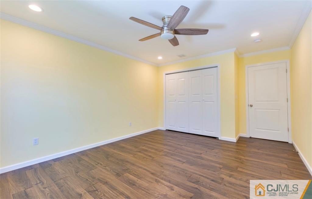 10 Markham Road Edison, NJ 08817 - Photo 18 of 23 an empty room with wooden floor and windows