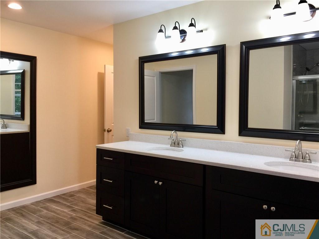 10 Markham Road Edison, NJ 08817 - Photo 20 of 23 a bathroom with a double vanity sink and a mirror