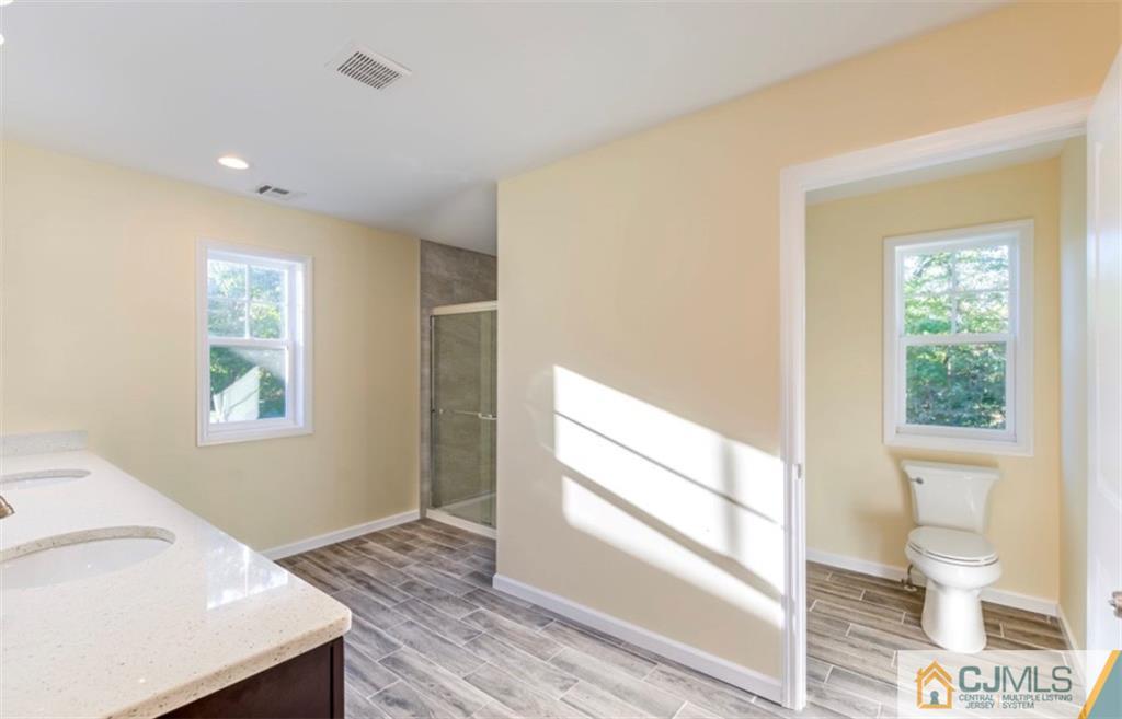 10 Markham Road Edison, NJ 08817 - Photo 21 of 23 a view of hallway with window and wooden floor